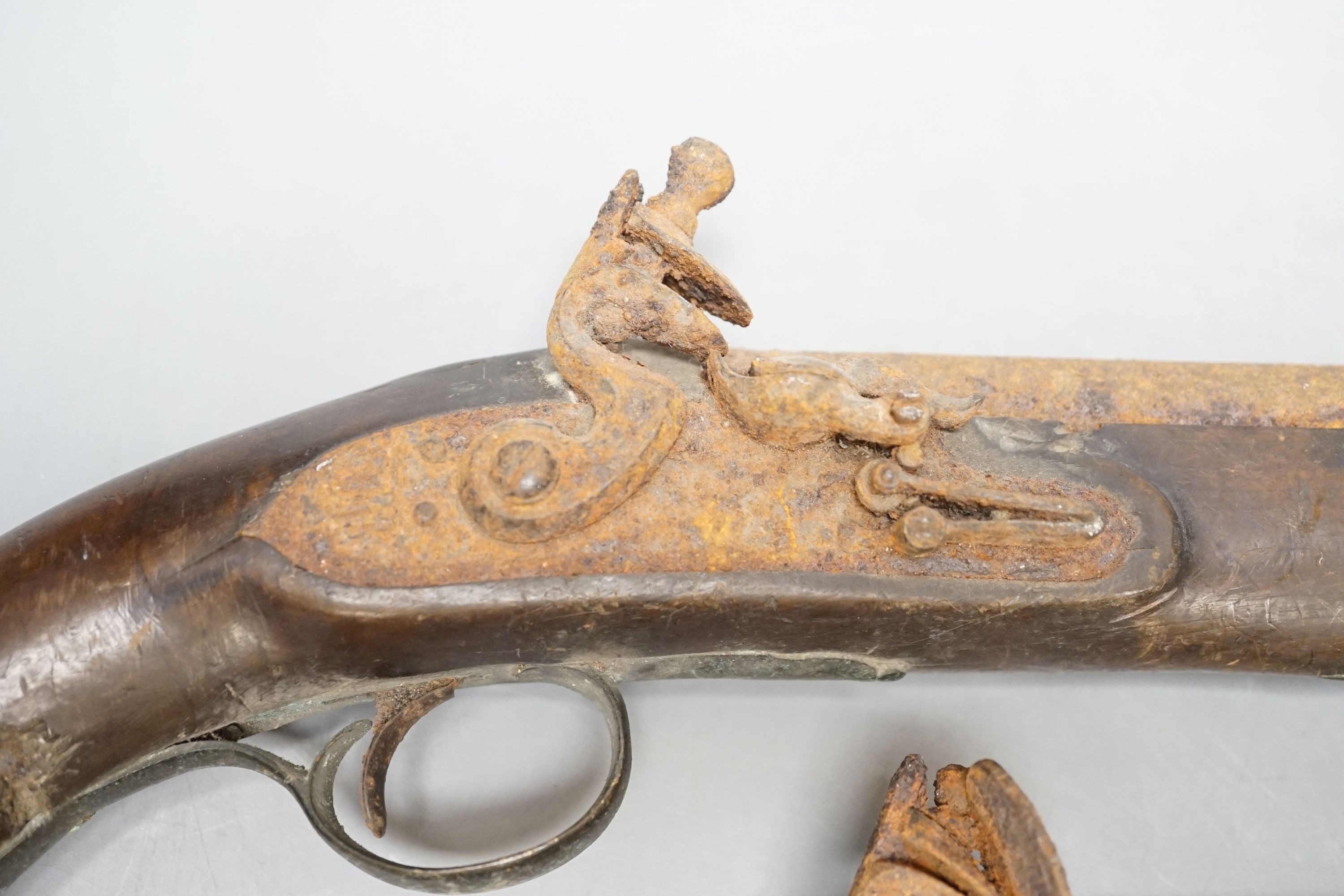 Two 19th century flintlock pistols and a pocket pistol, largest 40 cms long.